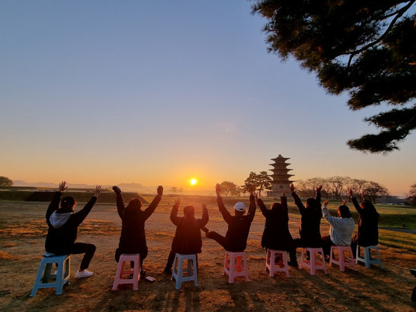 ‘금강오딧세이 테마버스’ 여행에 함께한 참여자들이 지는 저녁 노을을 보며 환호하고 있다/사진=협동조합 주인