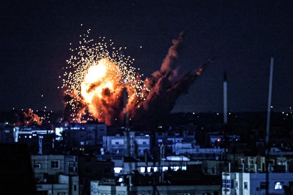 TOPSHOT - A ball of fire and smoke rise above buildings during an Israeli strike on Rafah in the southern Gaza Strip, on October 15, 2023. Israel embarked on a withering air campaign against Hamas militants in Gaza after they carried out a brutal attack on Israel on October 7 that left more than 1,400 people killed in Israel. (Photo by SAID KHATIB / AFP)
